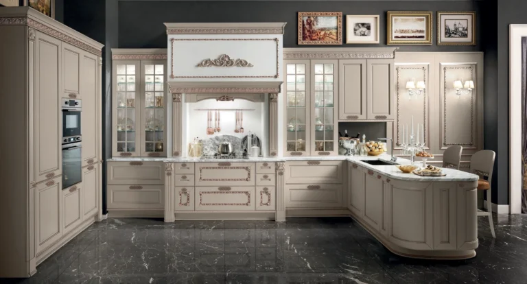 Cucina ad angolo con penisola Stosa Dolcevita 11 in laccato Cenere opaco con anticatura filo Bronzo e decori Bronzo, maniglie Rame Satinato Nero, top marmo Arabescato